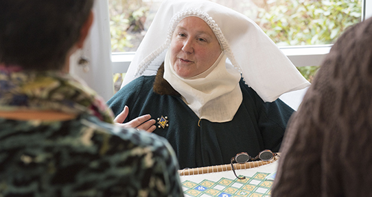 Demonstrating needlework at Medieval Workshop